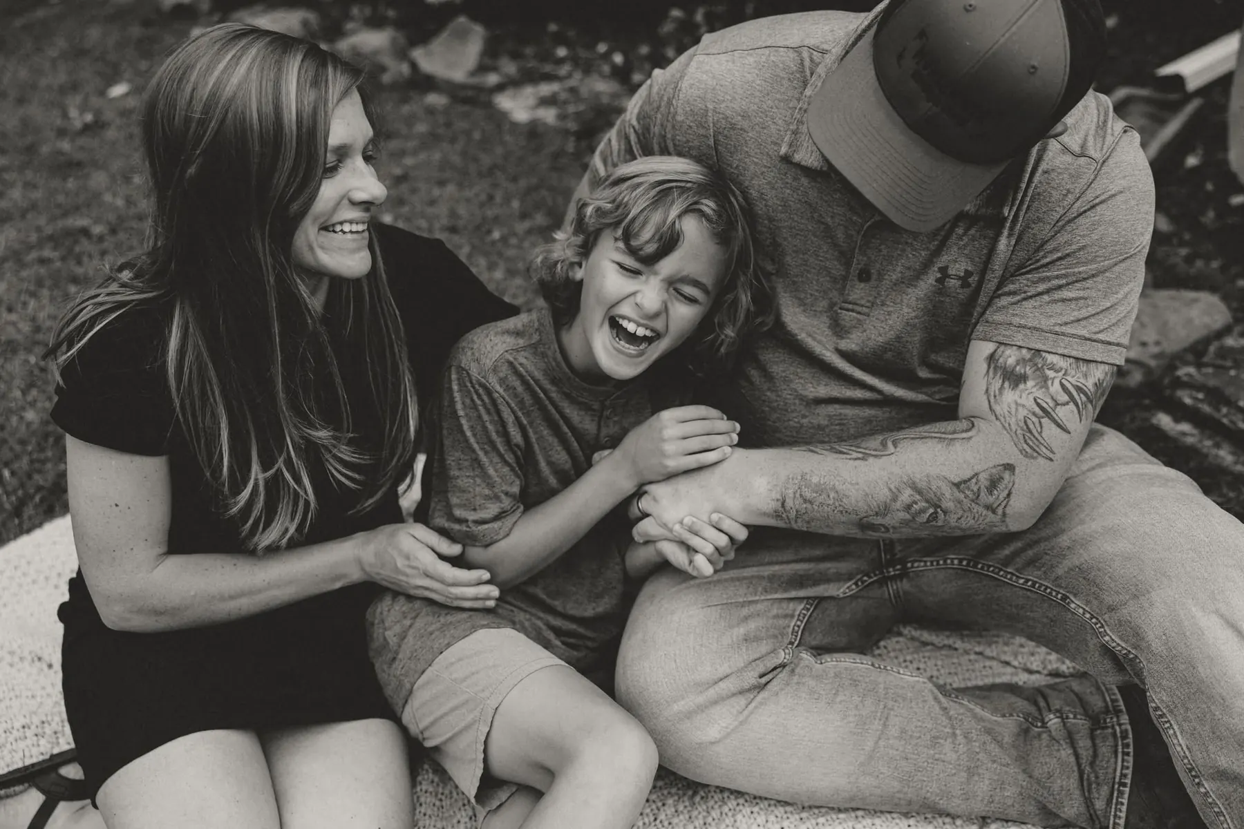 Family laughing together, black and white