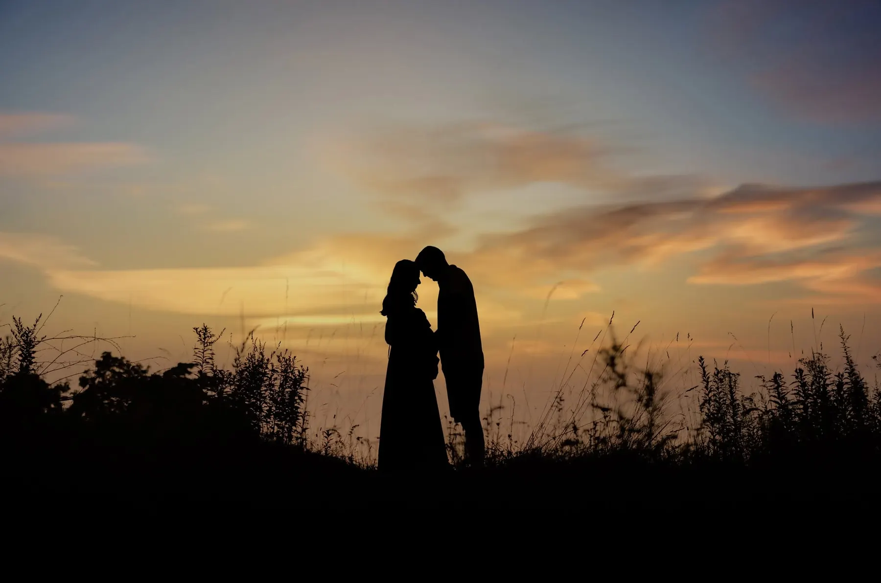 Couple silhouetted against the sunset